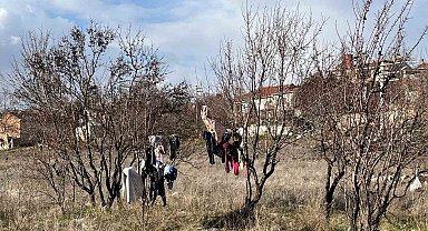 Kış ortasında kuruması için ağaca asılan elbiseler