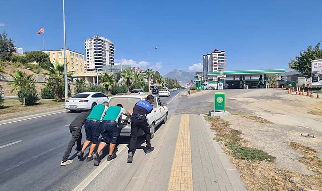 Yakıtı biten otomobili polis ve vatandaşlar iterek akaryakıt istasyonuna götürdü
