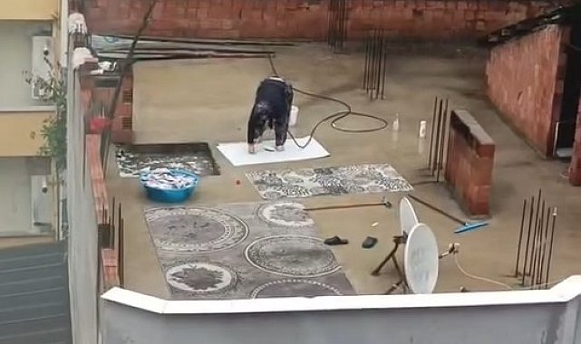 Yağmurlu havada çatıda halı yıkadı, görenler şaştı kaldı