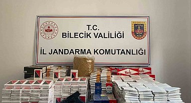 Jandarmanın baskın yaptığı evde kaçak tütün ve ruhsatsız silah ele geçirildi