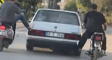 Motosikletliler, yolda kalan otomobili ayaklarıyla ittirdi