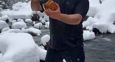 Kar ve soğuğa aldırmadı, ürününü tanıtmak için dereye girdi