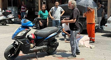 Kazada yaralanan genç kadına esnaftan şemsiyeli destek